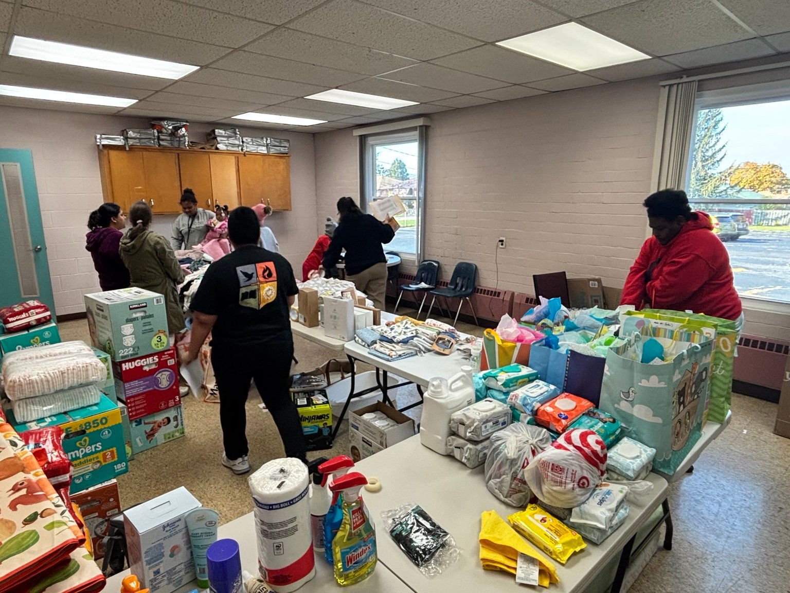 Tables of household and baby supplies at a community event